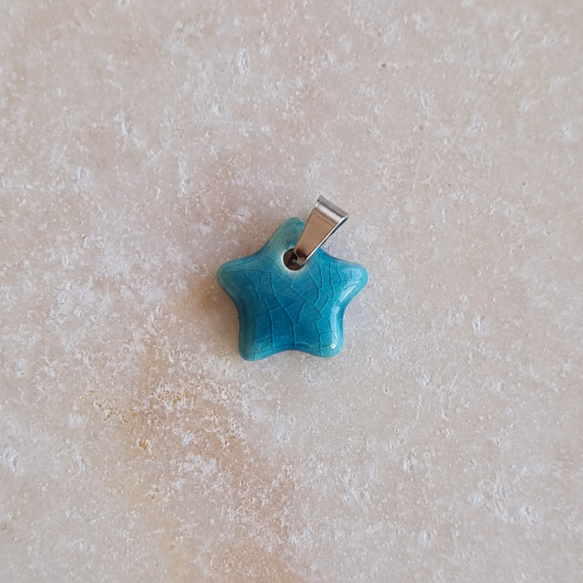 Colgante estrella de cerámica esmaltada turquesa
